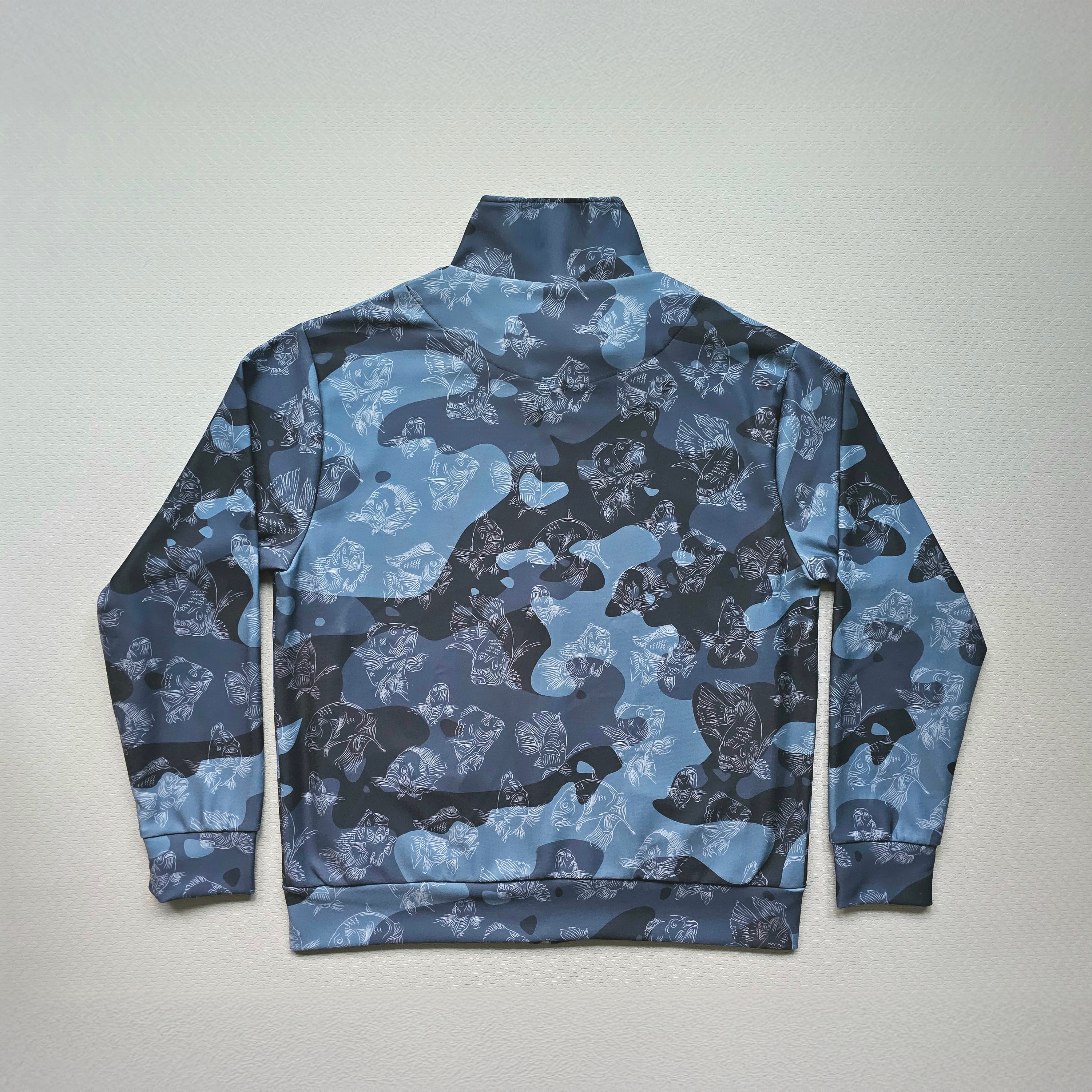 Blue camouflage jacket with swimming carp pattern on a light gray background