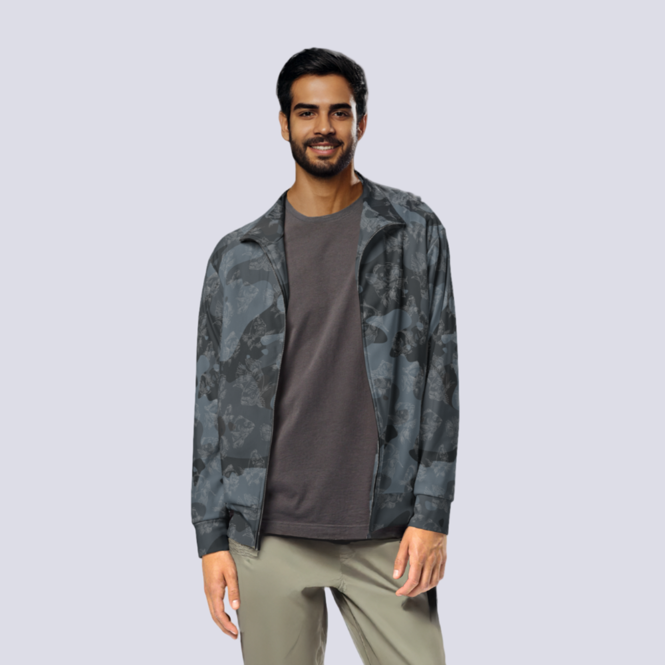 Man wearing a camouflage jacket over a gray shirt on a light gray background