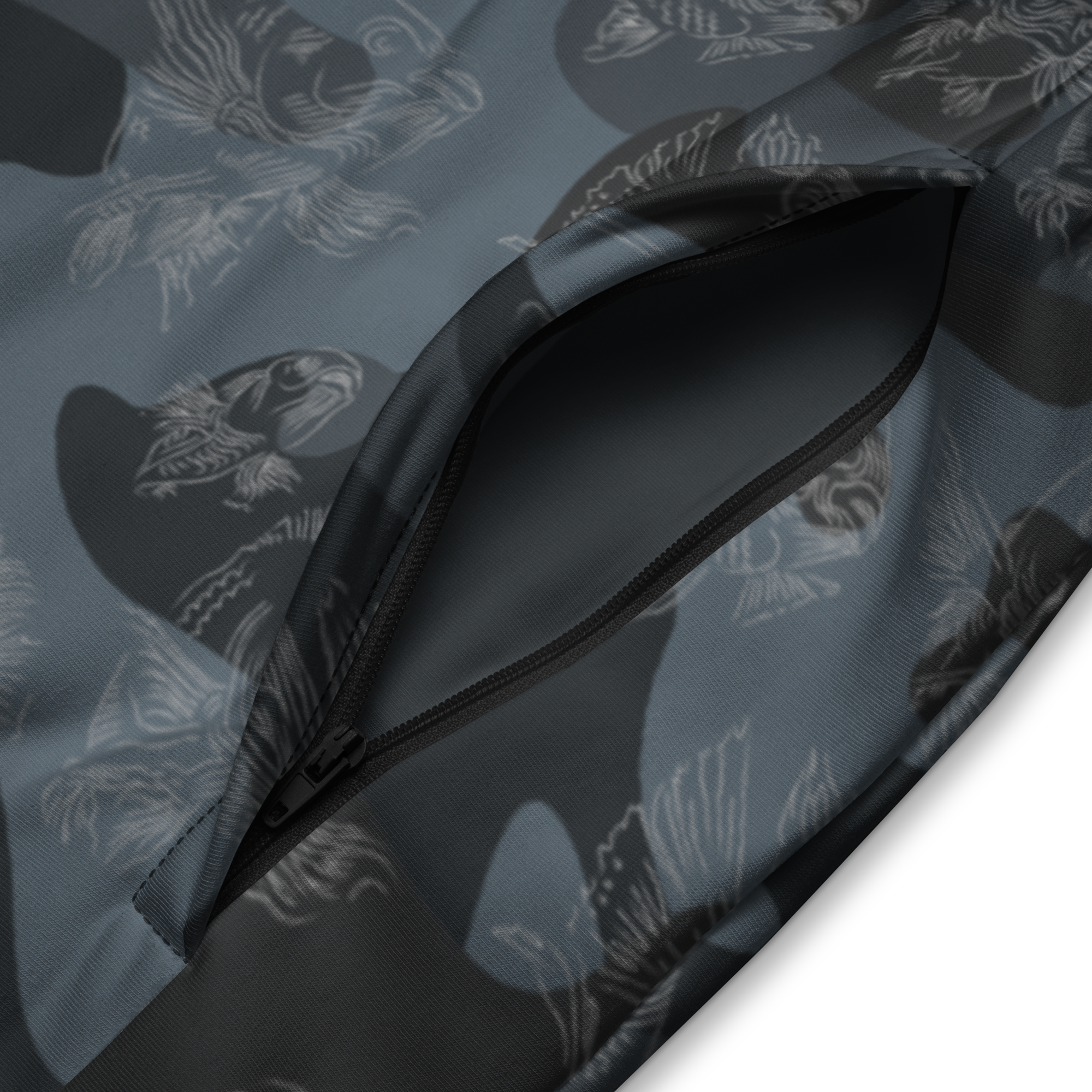 Close-up of a patterned fabric with a zipper, featuring abstract shapes on a dark background.
