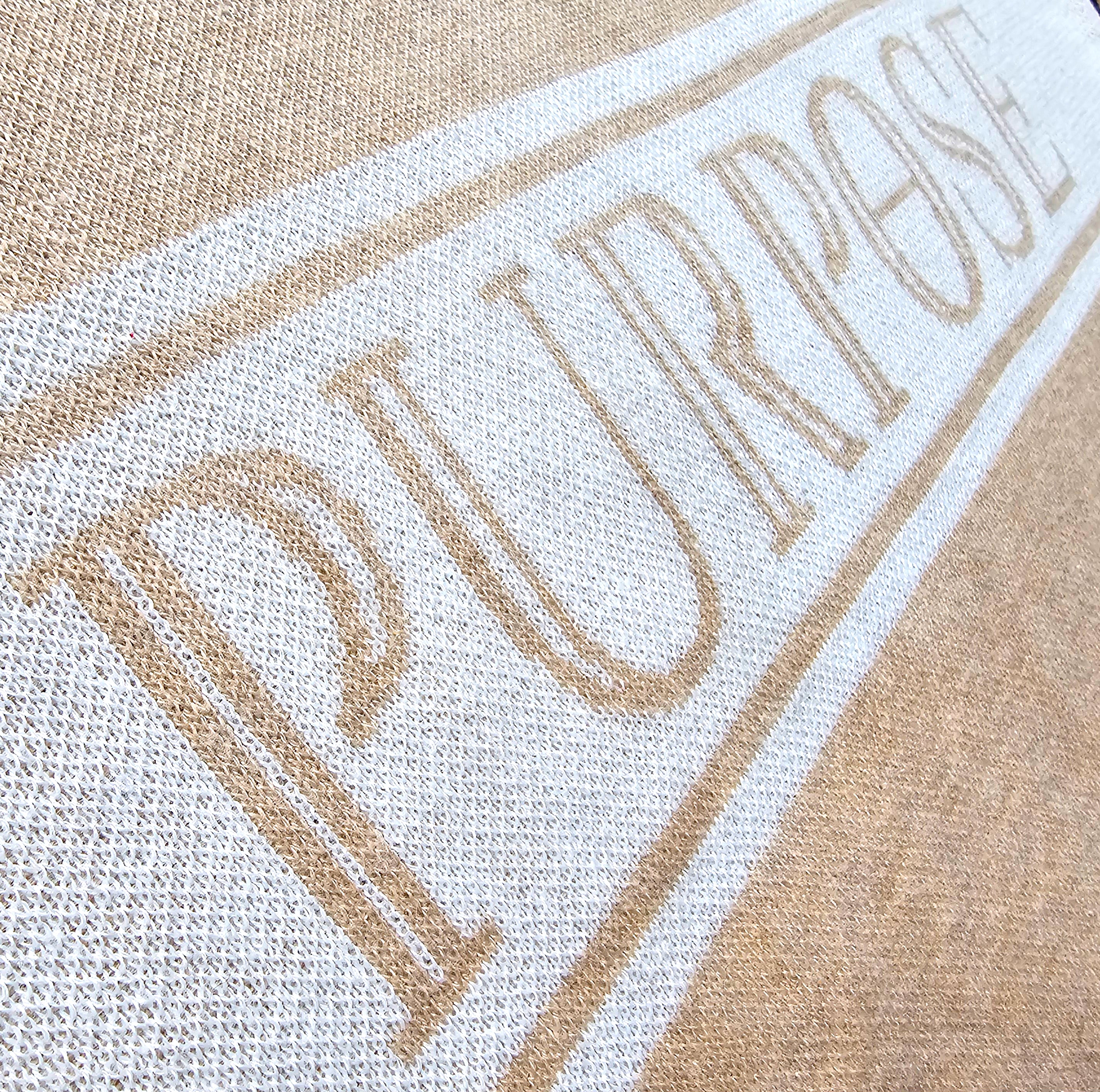 An angled close-up of the knitted word "Purpose" across the chest of the sweater.