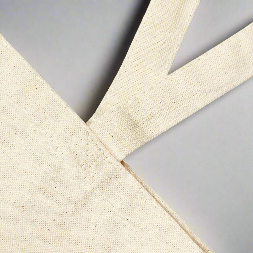 A close up the reinforced stitching at the base of the handles where they attach to the bag.
