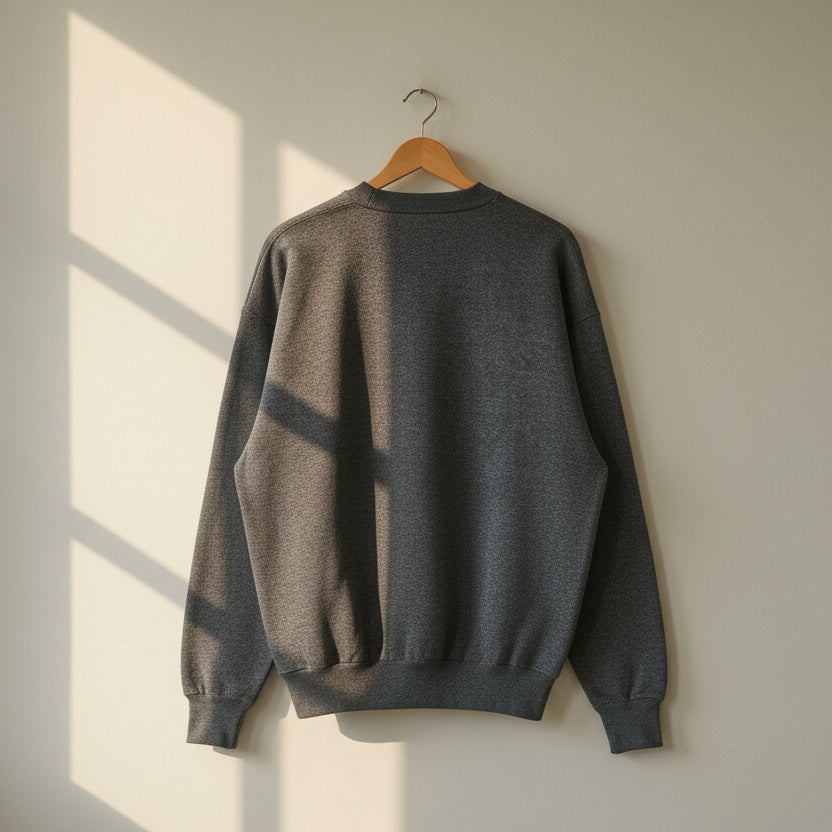 The back side of the marled navy blue sweater.