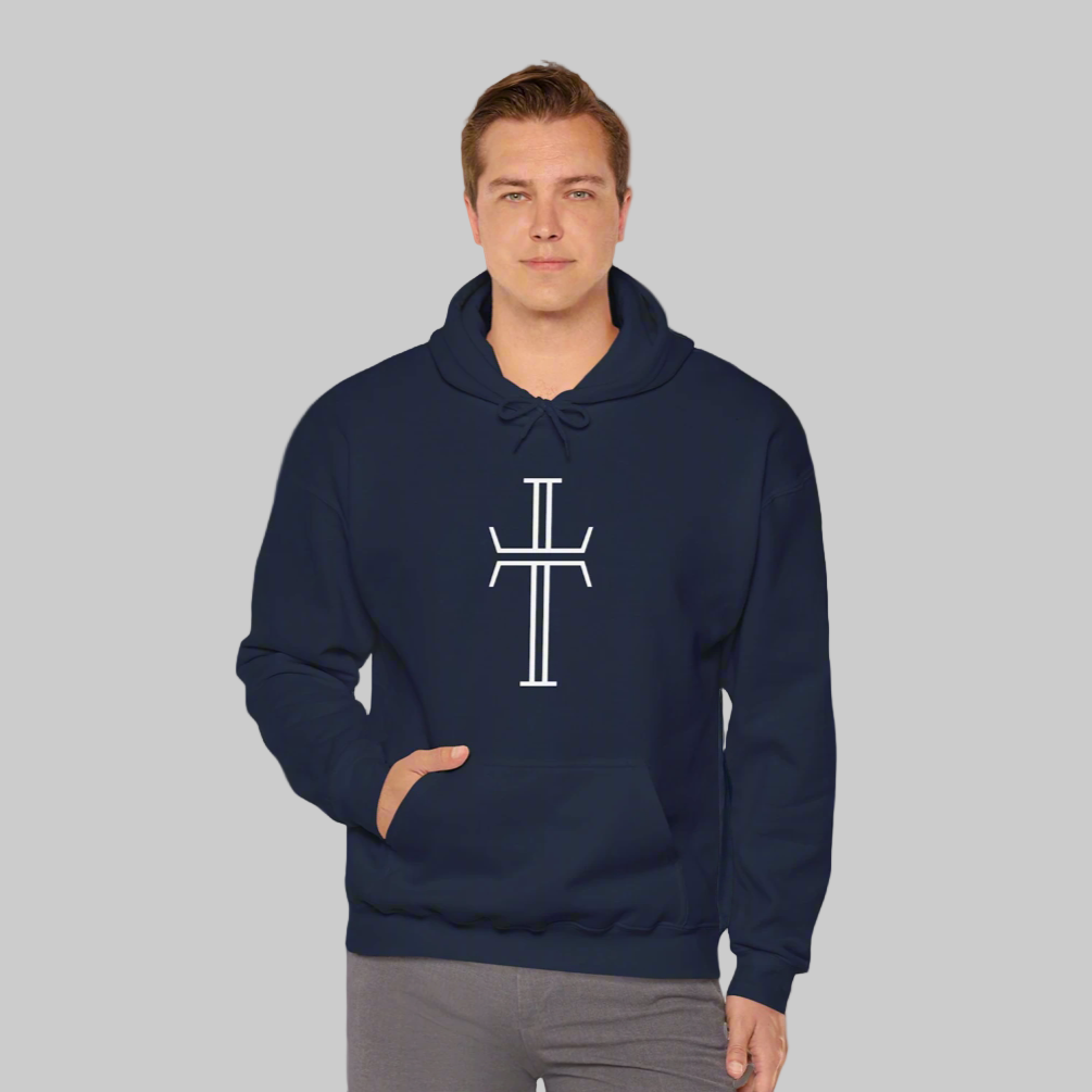 A tall, handsome man in gray denim wears a navy hoodie that displays the large white Purpose cross logo on the front.