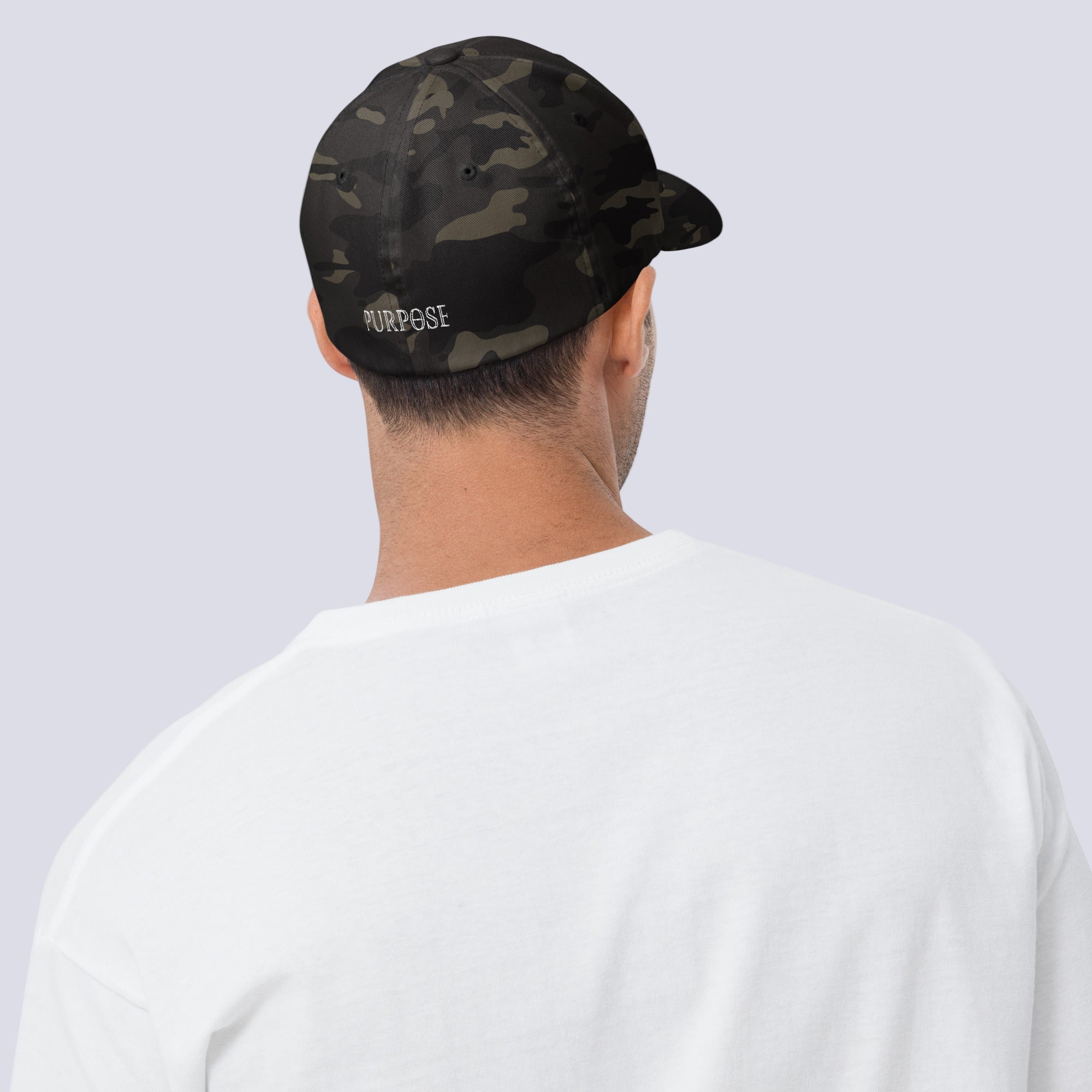 Person wearing a black camouflage cap with 'PURPOSE' text on a white background
