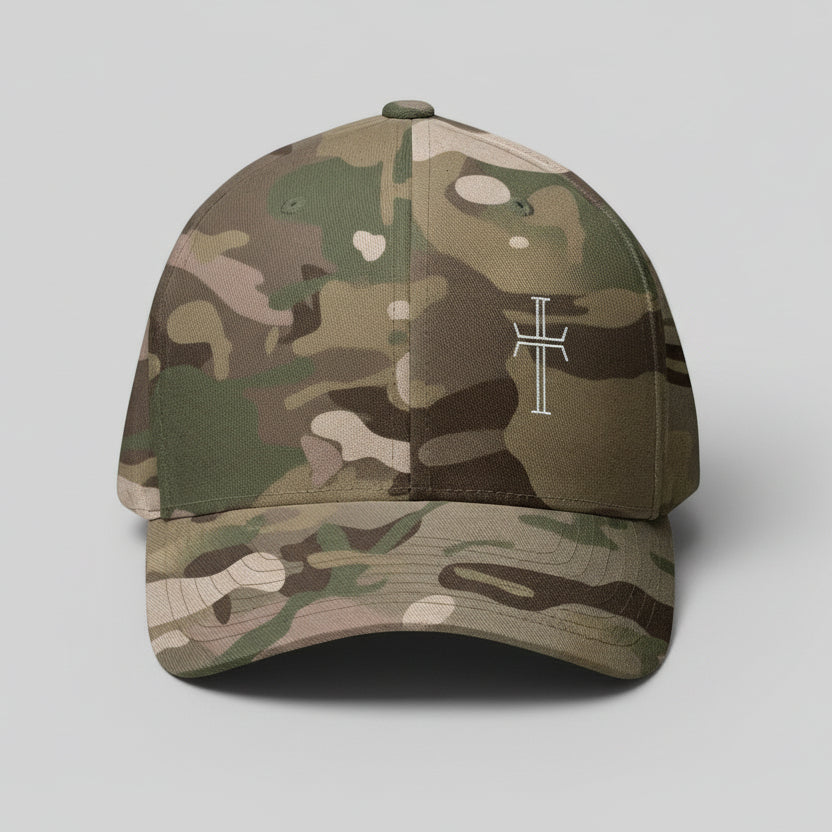 Multicam green baseball cap with a white cross on left front panel on a gray background
