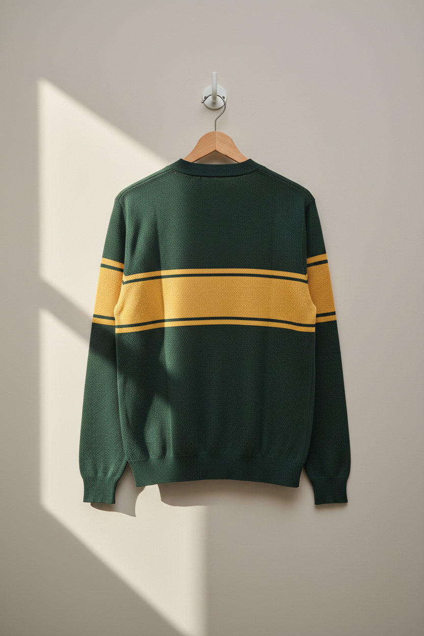 The back of the forest green sweater laying against a neutral background. The three stripes in a mustard-yellow color are continuing across the upper back and arms.