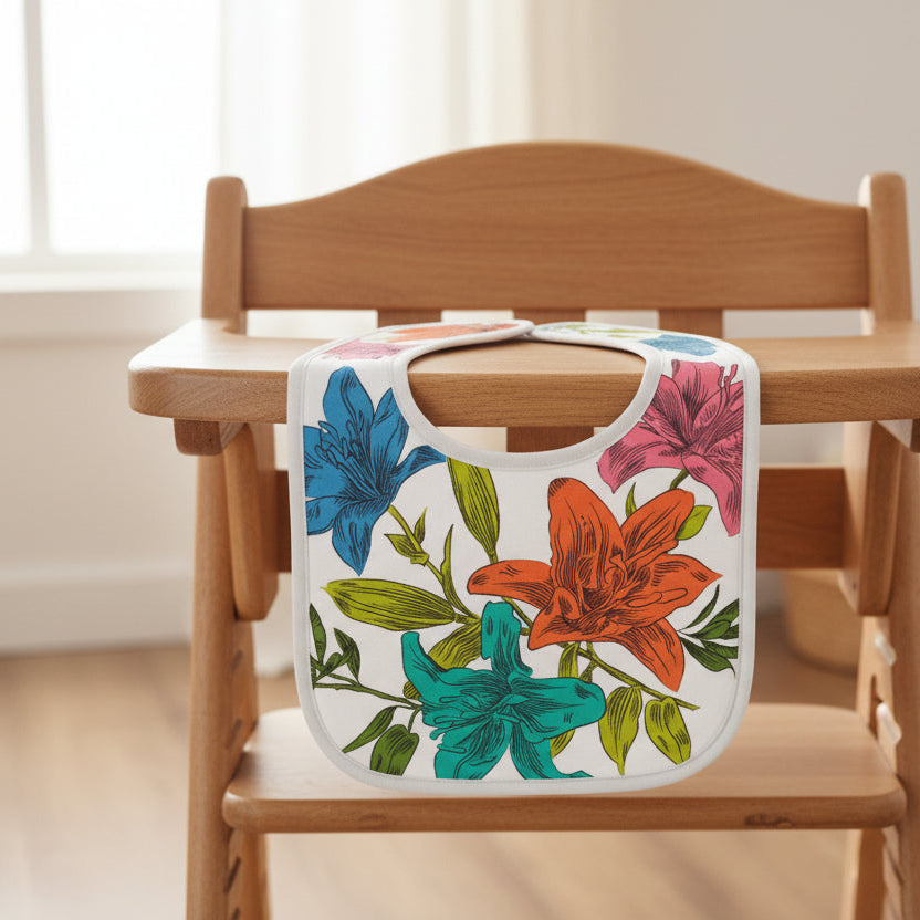 Floral-patterned bib draped over a highchair tray in a blurred room