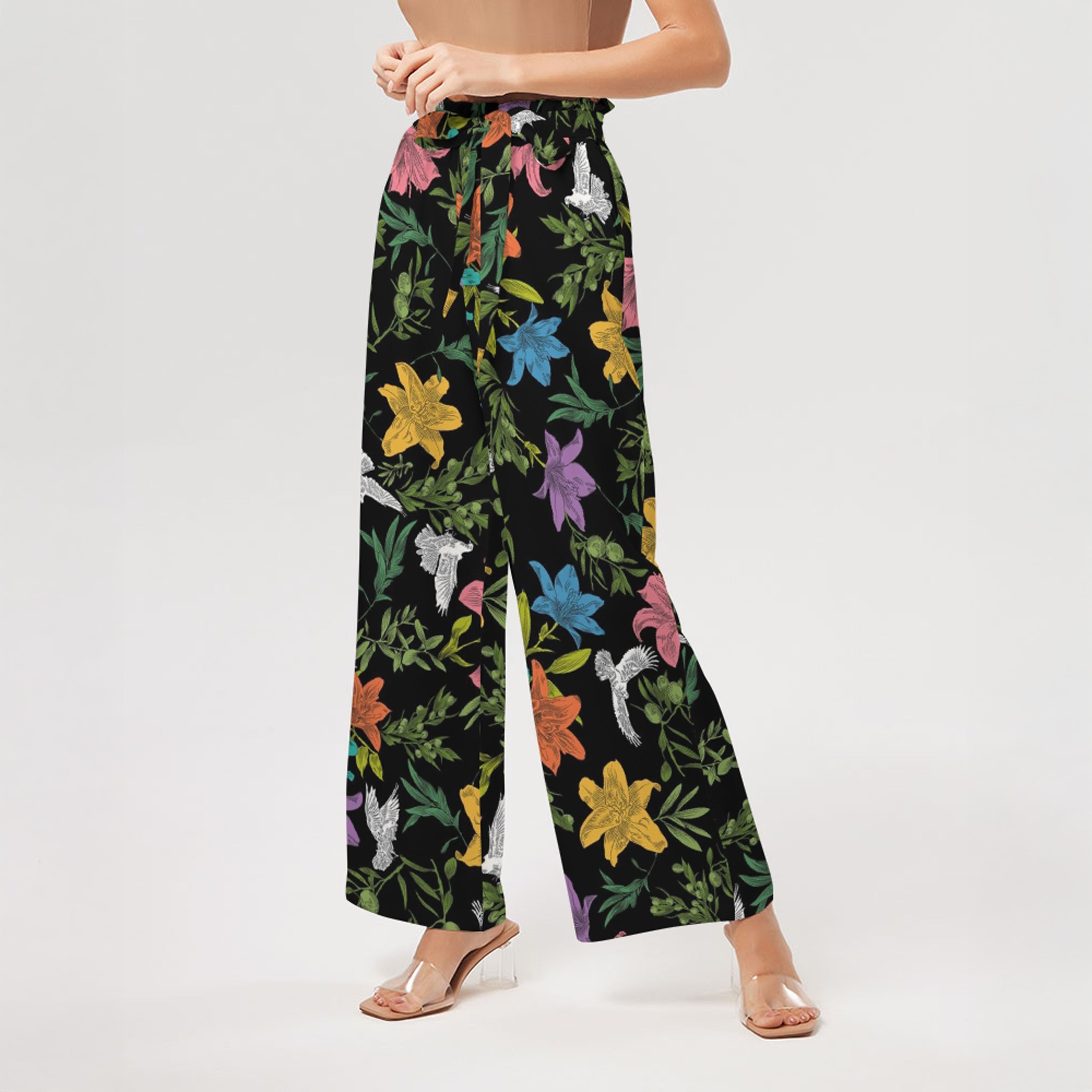 Close up of floral-patterned pants worn by a person on a white background