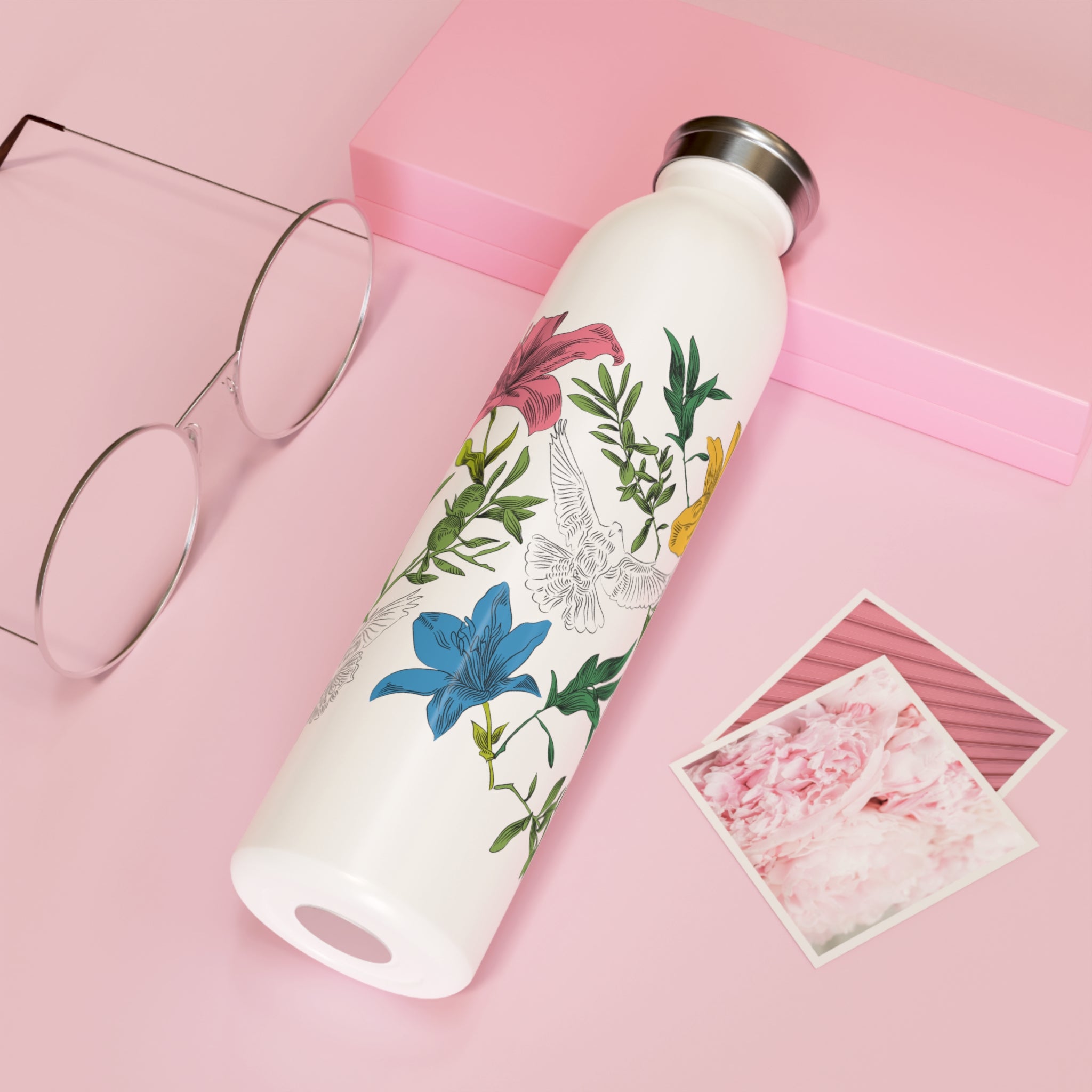 White water bottle with floral and dove design on a pink background