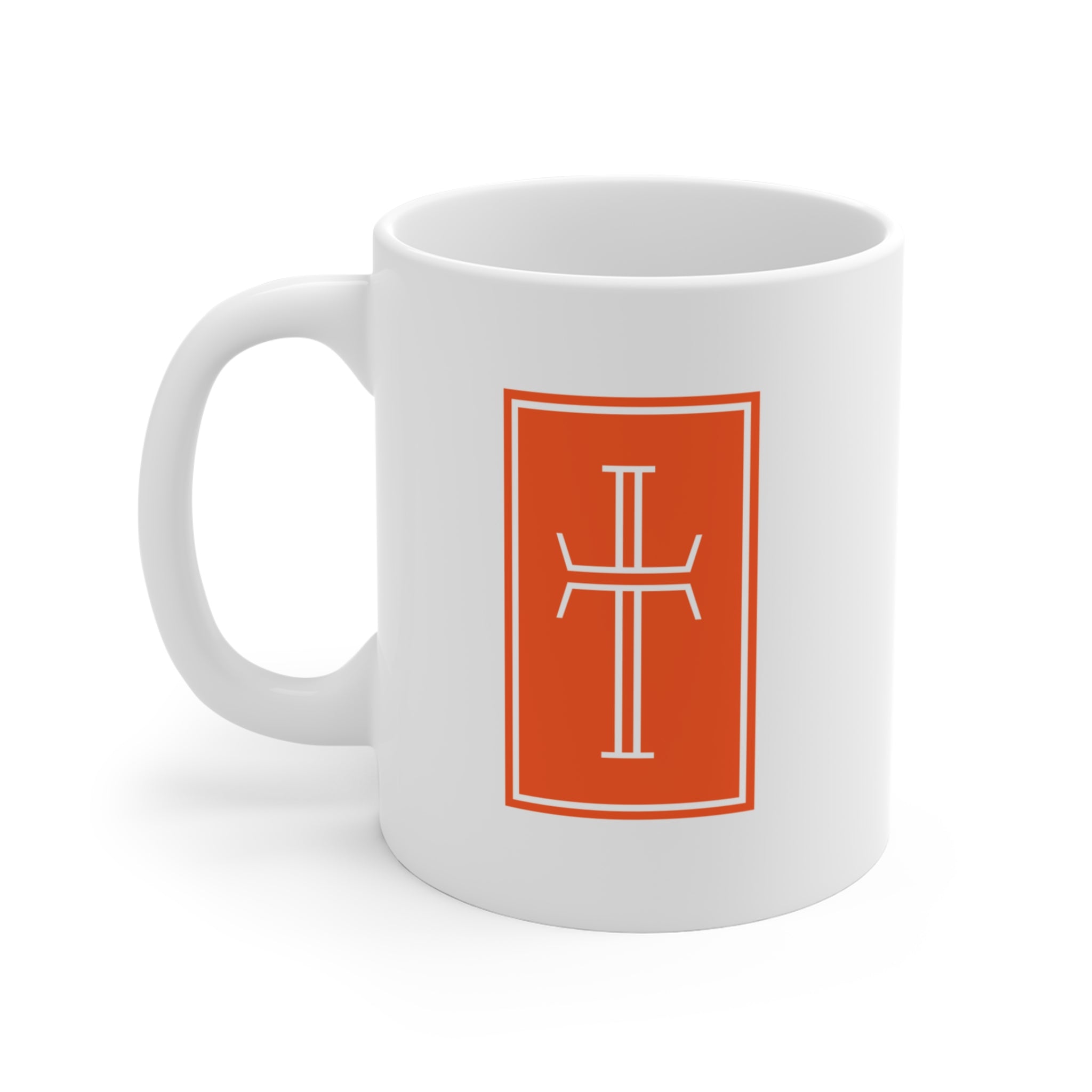 Front of a white mug displaying a white cross against the vibrant sardius umber of background.