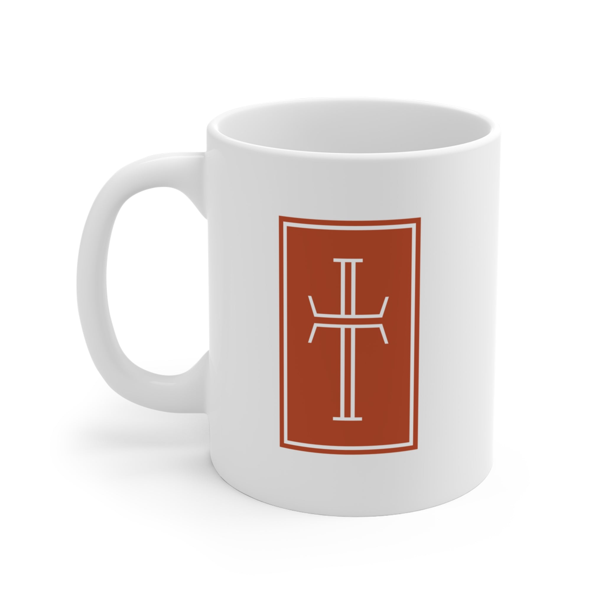 Front of a white mug displaying a white cross against a warm, earthy-toned background.