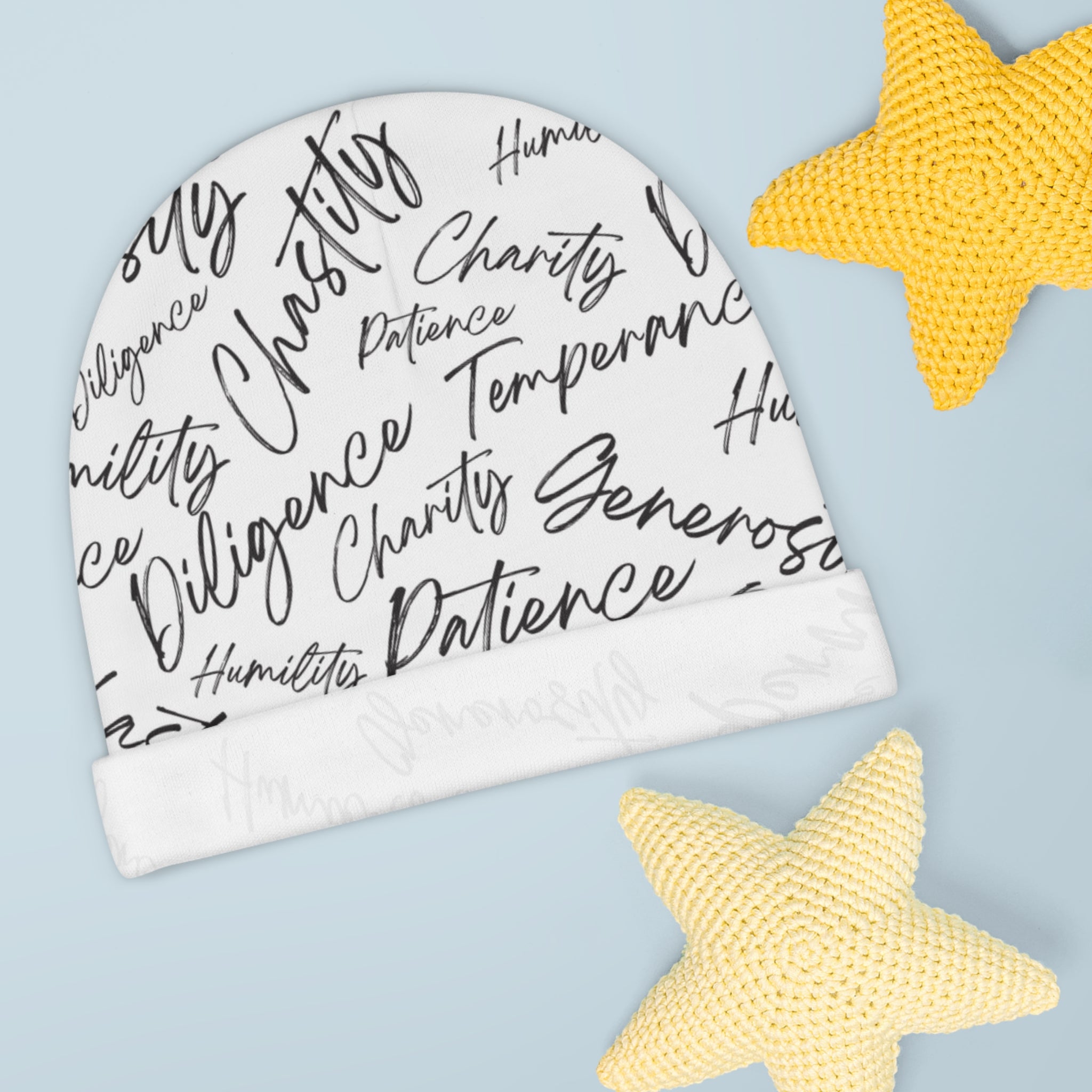 White beanie with black text on a light blue background with yellow stars.