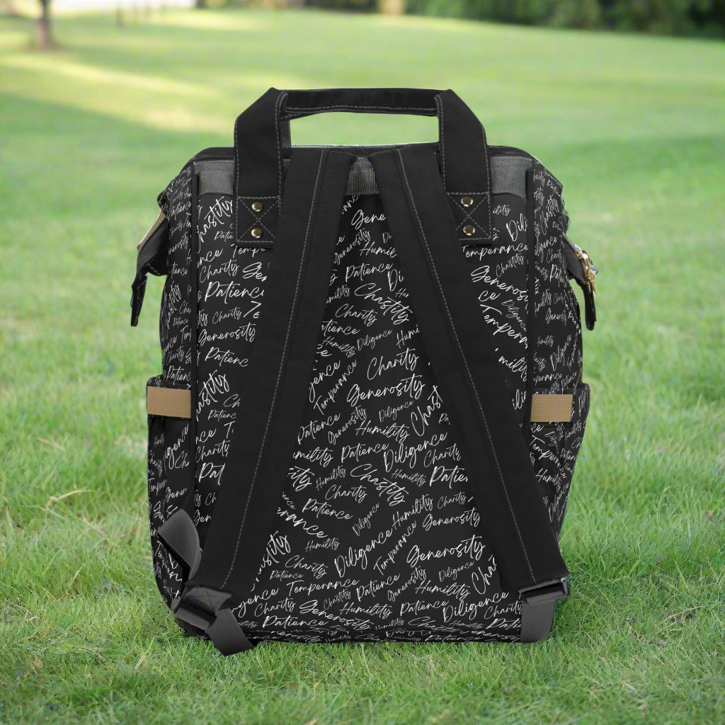 Back of backpack with adjustable straps sitting on the grass in a park