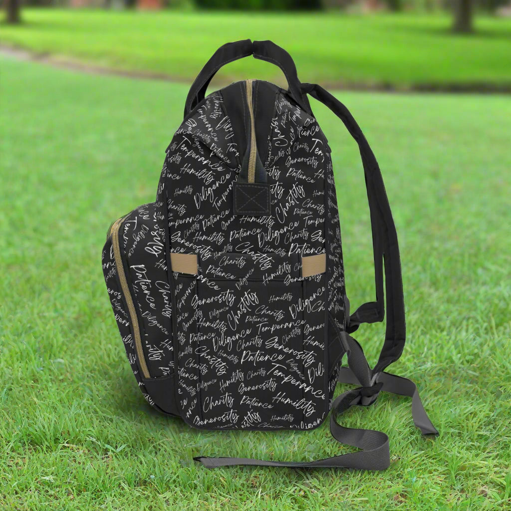 Left side of backpack sitting on the grass in a park