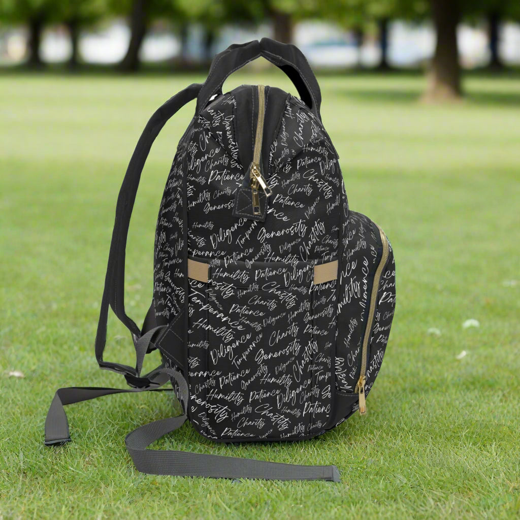 Right side of backpack with adjustable straps sitting on the grass in a park