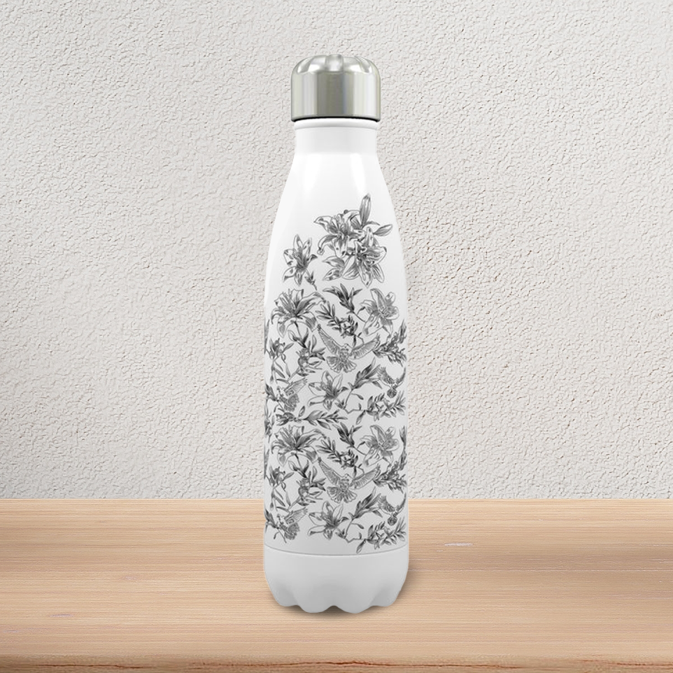 A white, stainless steel water bottle with stainless steel screw cap stands on a pine-wood console. It displays a black and white floral and dove pattern on the front.