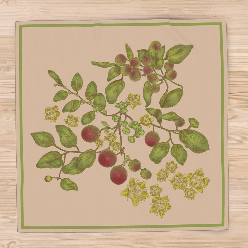 A square, beige, silk scarf with green border and a floral pattern with varied tones of green, red, and yellow adornments of the ziziphus plant, lay atop a pine hardwood surface.