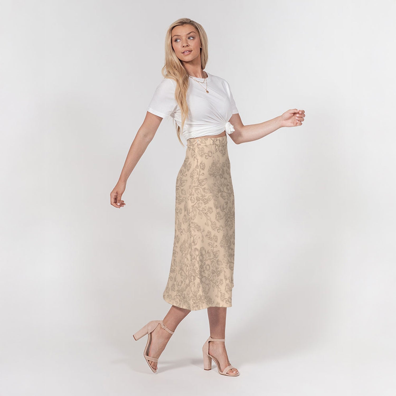 Woman wearing a white top and beige patterned skirt on a white background