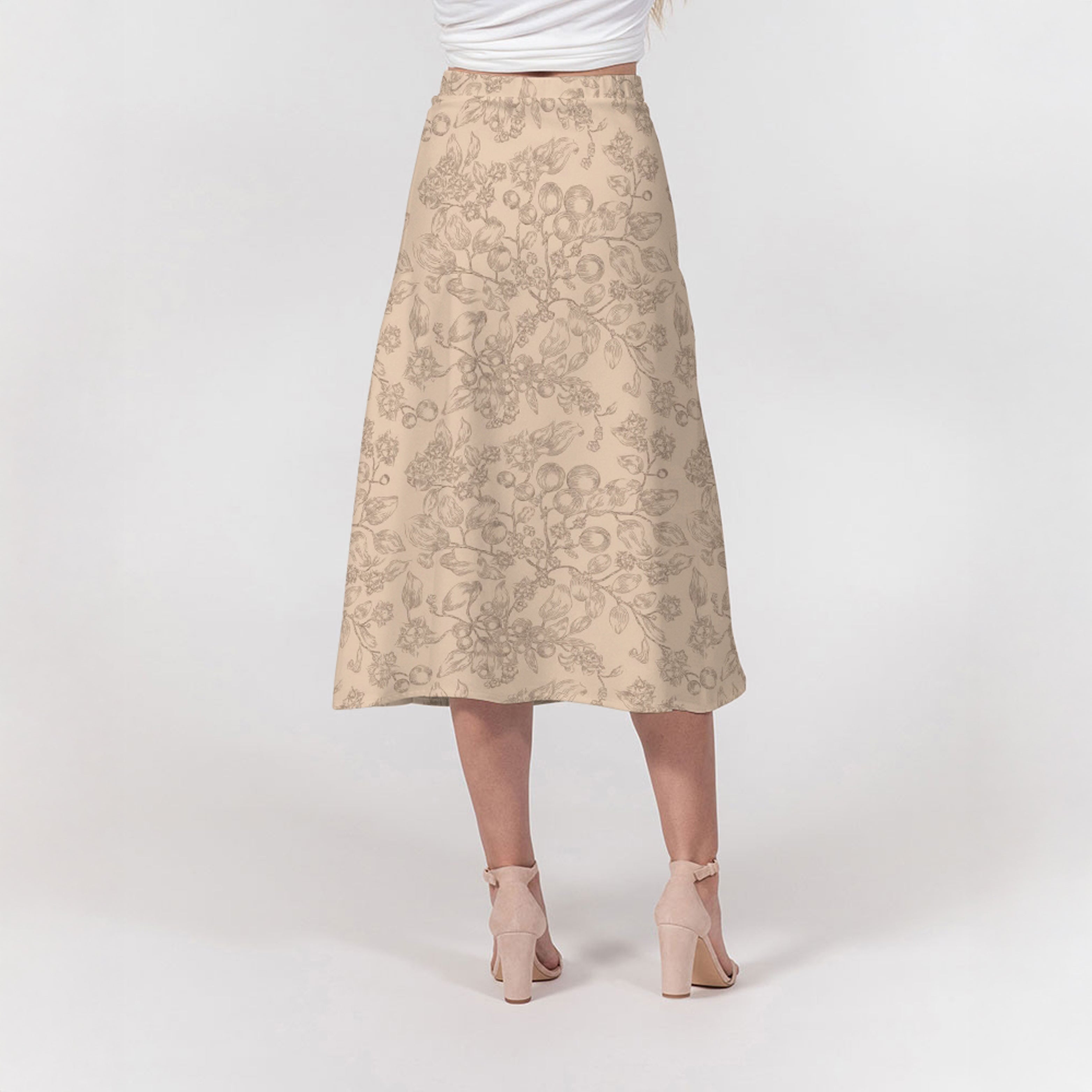 Beige floral skirt worn by a person on a white background