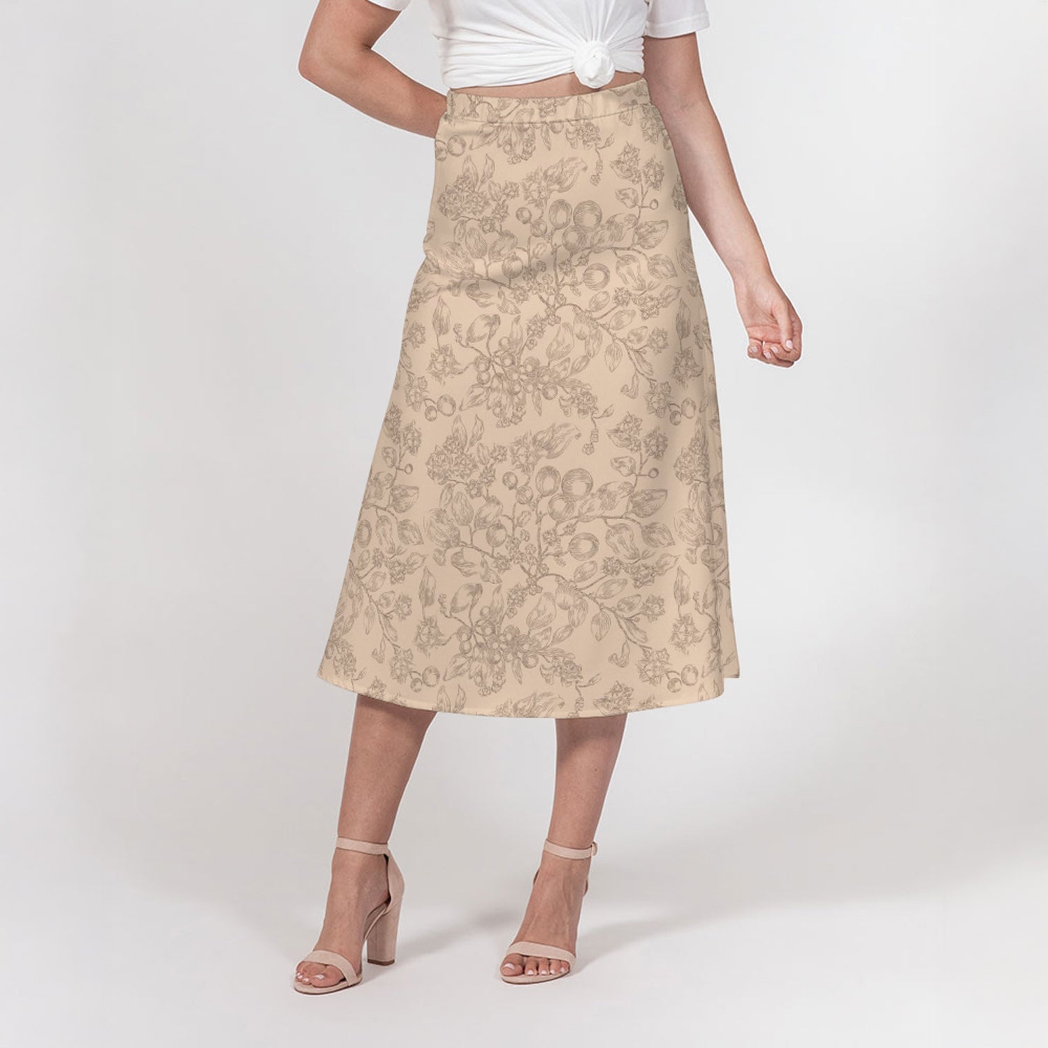 Beige floral skirt worn by a person on a white background