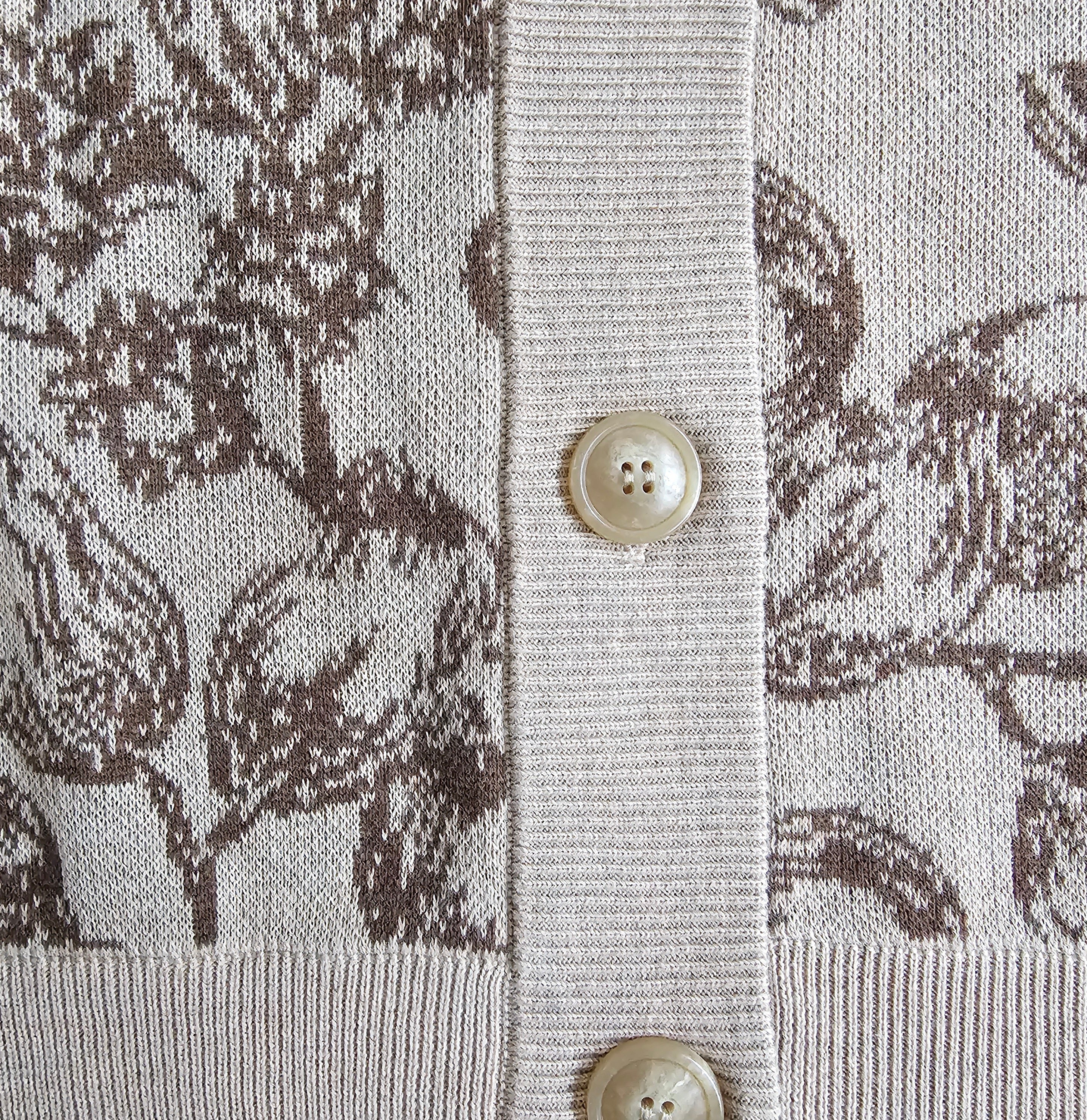 Close-up of a patterned fabric with buttons, featuring a floral design.