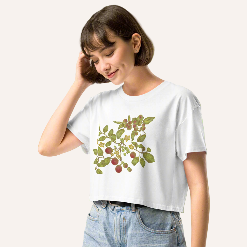 Woman in jeans and cropped t-shirt  with an image of a green plant with red berries on the front