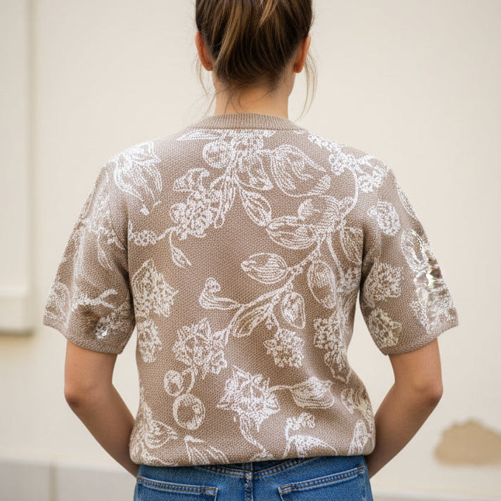 Floral patterned knitted tee on a plain background