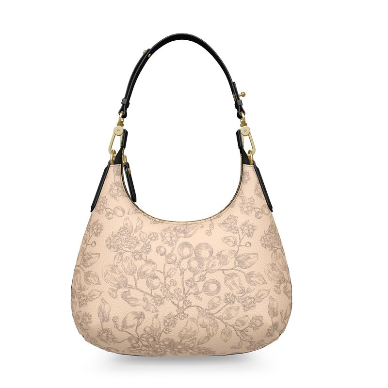 Beige handbag with floral pattern, black leather handle, and gold accents on a white background. Christian handbag.